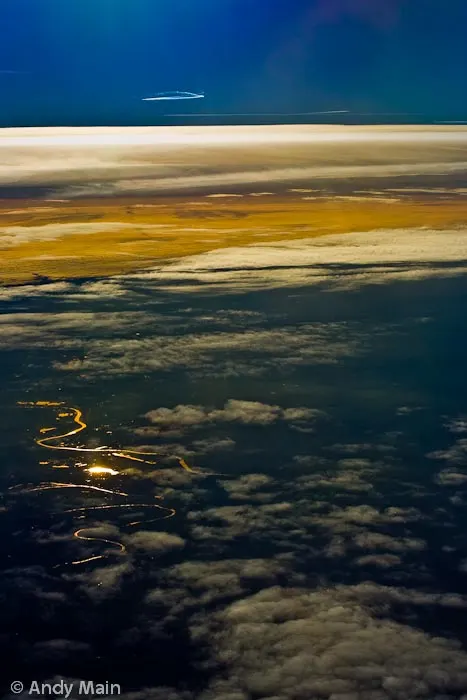 From miles above the Seine snakes through paris and is highlighted by the setting sun.